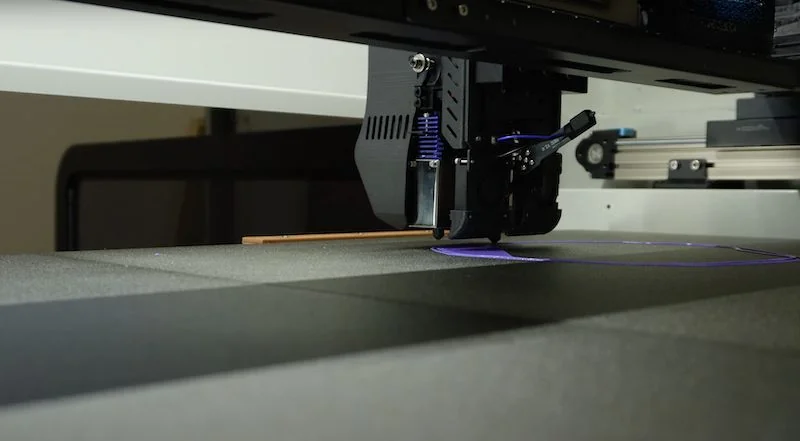 Creatbot D1000 3D printer in action, printing a purple design on a textured surface in an industrial setting.