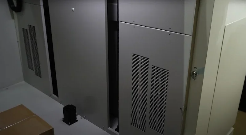 The Creatbot D1000 3D printer features a large industrial design with ventilation panels and adjacent boxes, ideal for professional-grade printing.