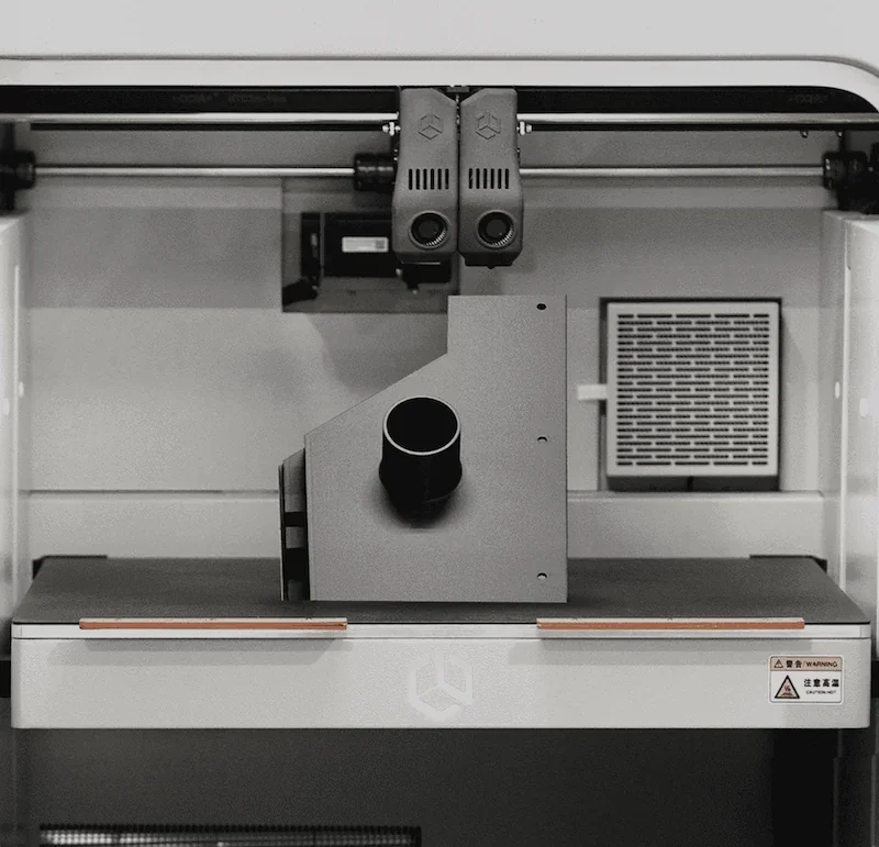 Creatbot D1000 Pro HS 3D printer interior, showcasing dual extruders and a large printed part, emphasizing industrial functionality.