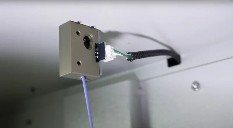 Creatbot D1000 Pro HS 3D printer internal component, showing a filament sensor connected by wires inside a metal enclosure.