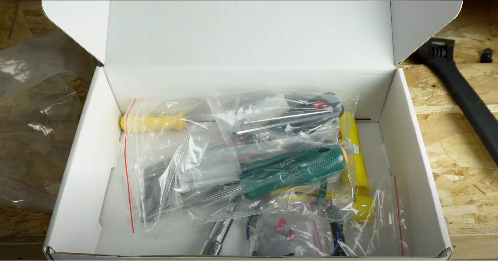 Toolset in a white box on a workbench, possibly for Creatbot D1000 Pro HS assembly or maintenance; various hand tools in plastic bags.