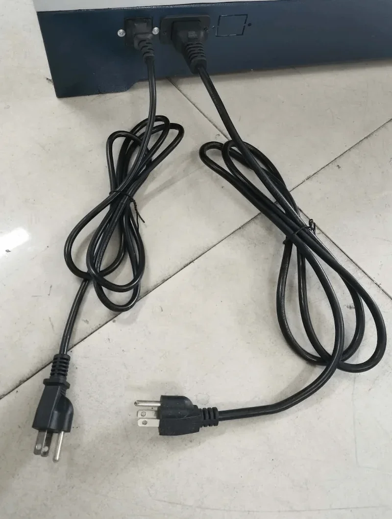 Power cords plugged into Creatbot D600 Pro 3D printer on tiled floor.