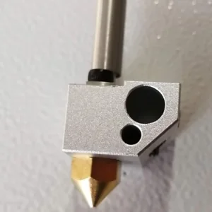 CreatBot D600 Pro extruder nozzle, metallic finish on a textured surface, used for precise industrial 3D printing.