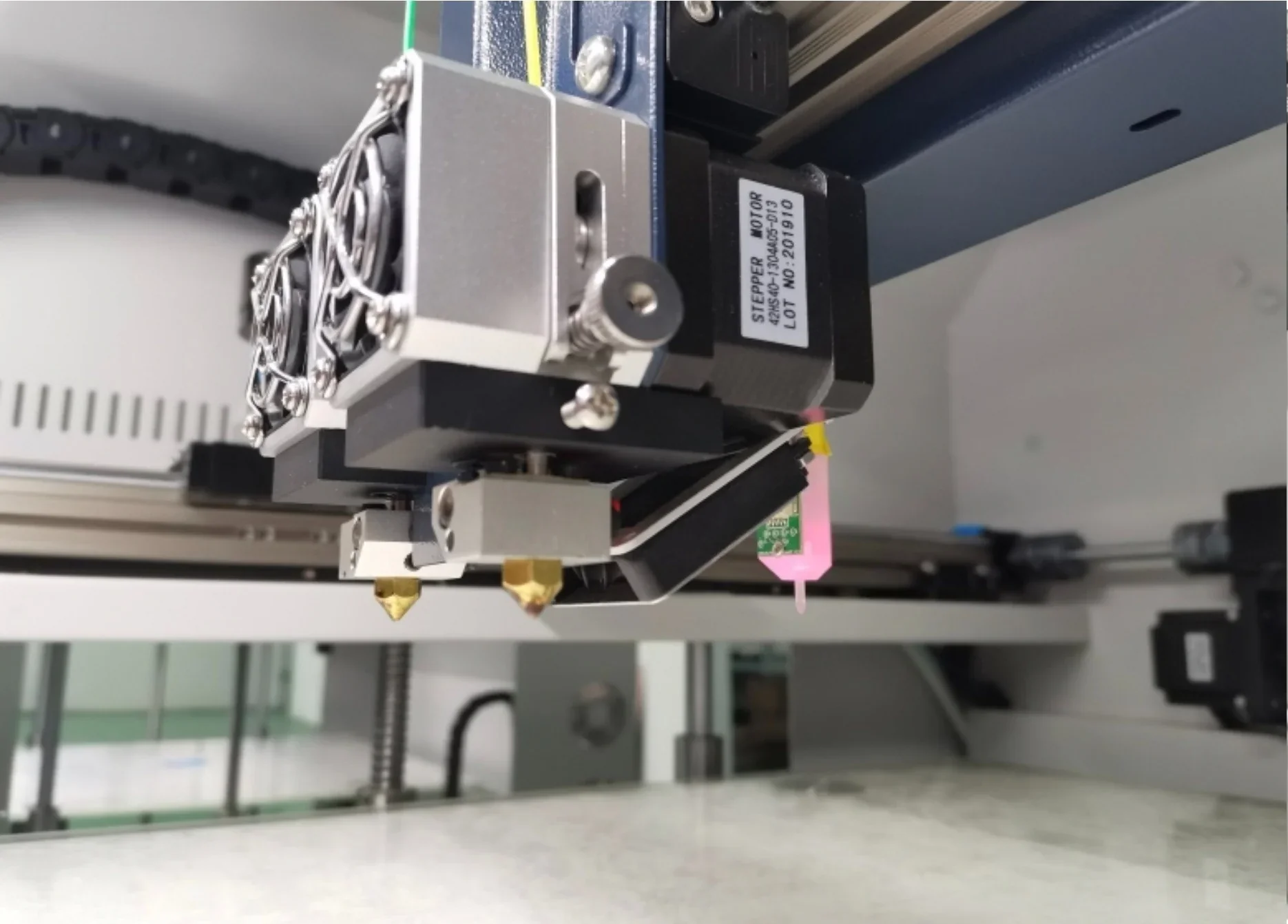 Creatbot D600 Pro 3D printer nozzle and motors close-up inside printer, showcasing precision components and wiring setup.