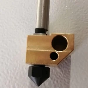 Brass 3D printer nozzle component for Creatbot D600 Pro with metal tube, set against a textured white background.