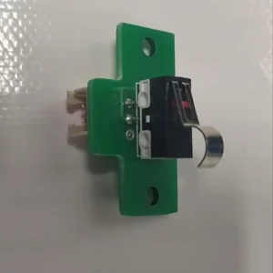 Switch component on green mounting bracket, potentially created by Creatbot D600 Pro 3D printer, set against a neutral background.