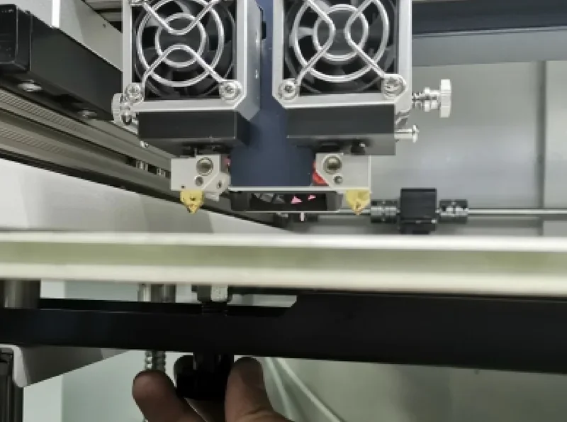 CreatBot D600 Pro 3D printer dual extruders on a print bed with precise mechanical components and cooling fans for industrial printing.