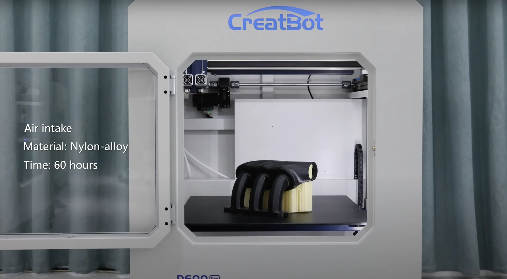 Creatbot D600 Pro printing nylon-alloy air intake over 60 hours. Machine open with part visible inside, branding on top.