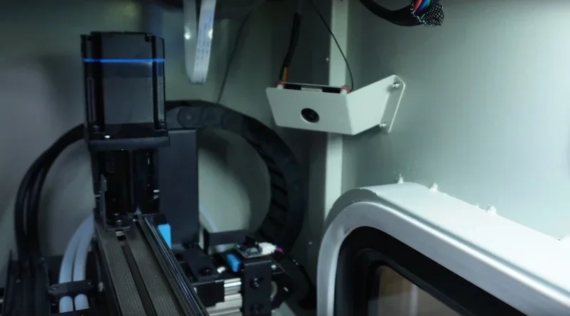 Creatbot D600 Pro2 HS 3D printer interior shows mechanical components and wiring, highlighting precision and design within the enclosed chamber.