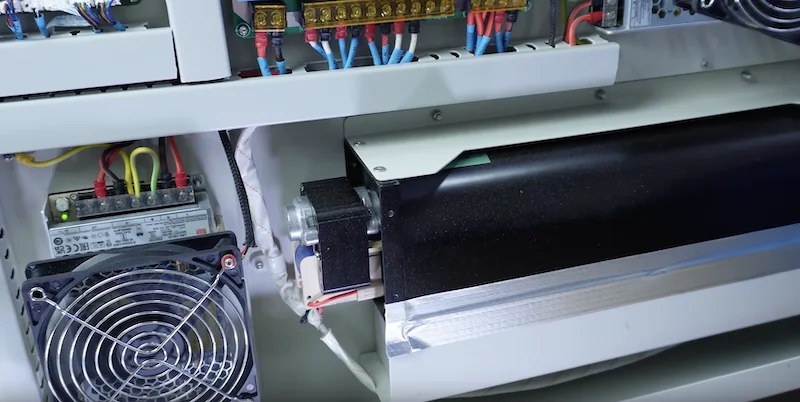 Inside view of CreatBot D600 Pro2 HS showing electronic components, wiring, a fan, and a black component, highlighting advanced 3D printer internals.