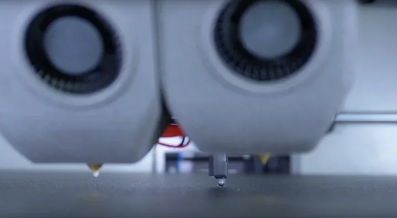 Creatbot D600 Pro2 HS 3D printer nozzle close-up during operation, focusing on precision parts being created on a flat printing surface.