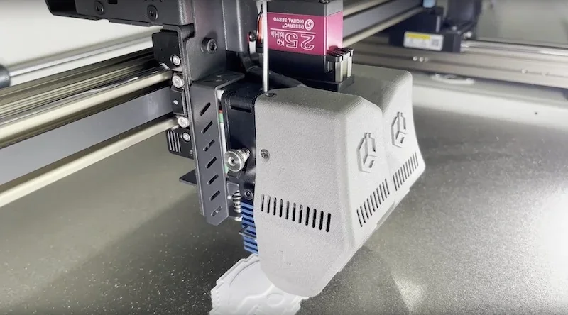 Creatbot D600 Pro2 HS 3D printer with dual-extruder setup, printing intricate white part, showcasing advanced technology in a metal enclosure.