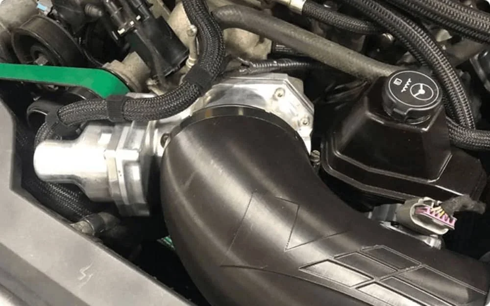 Engine parts manufactured by the Creatbot D600 Pro2 HS, featuring a black curved component and surrounding mechanical elements.