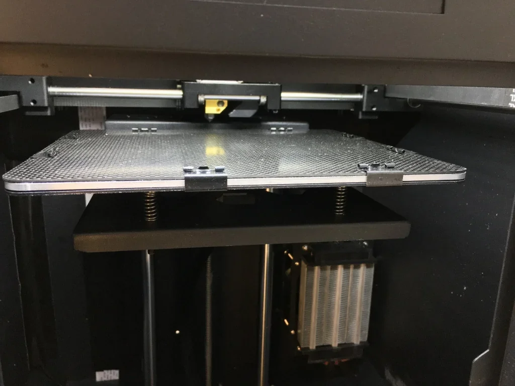 CreatBot F160 3D printer showing build platform, extruder, and internal components, ready for printing samples.