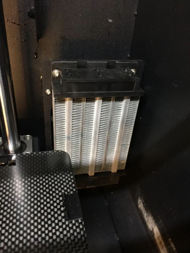 Creatbot F160 3D printer heat sink component, black and metallic, within the interior chamber, showing structural details and finish.
