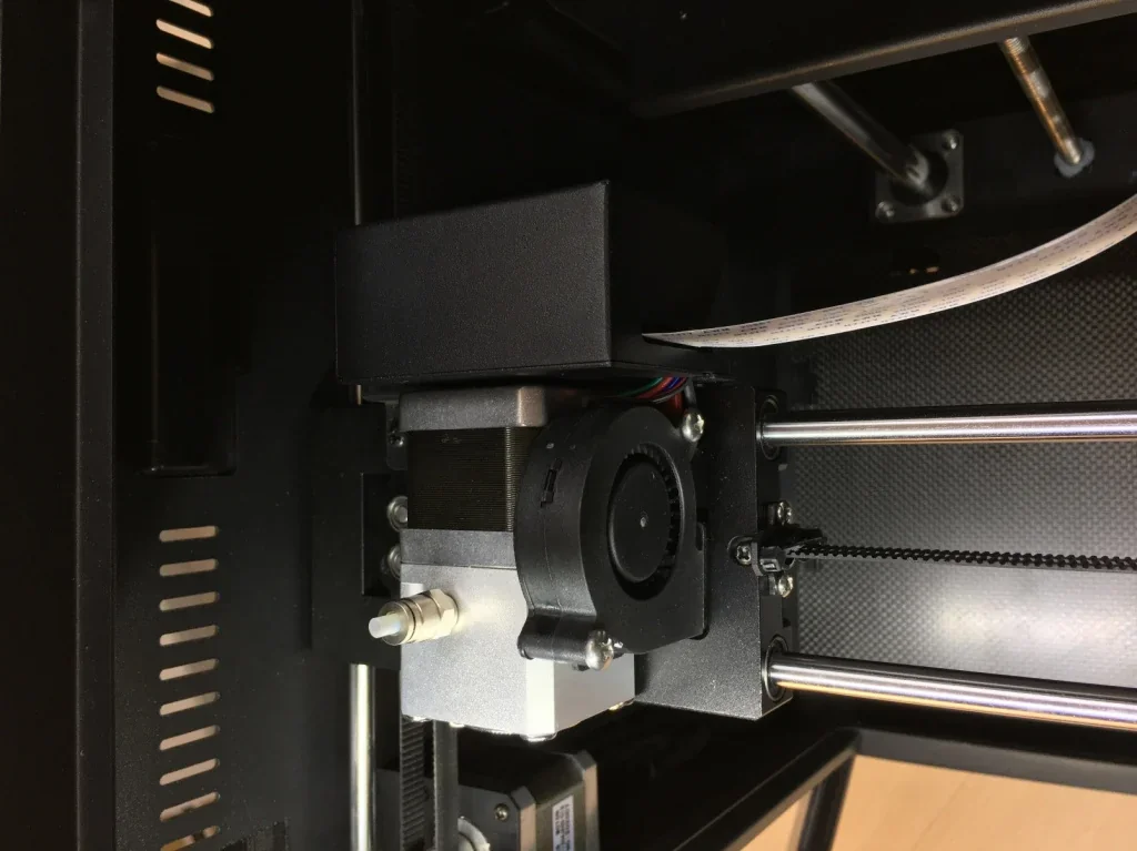 Creatbot F160 3D printer close-up, showing the extruder and belt mechanism inside a metal casing, highlighting advanced design and precision parts.
