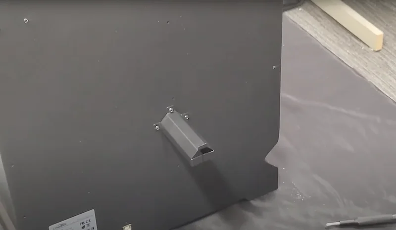 Rear view of Creatbot F160 3D printer showing filament holder on a black surface in a tech setting, highlighting machine's structure and design elements.