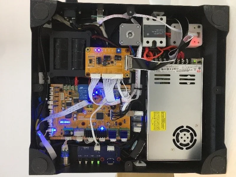 Creatbot F160 internal components with electronic circuit boards, wiring, and power supply visible inside a black enclosure.