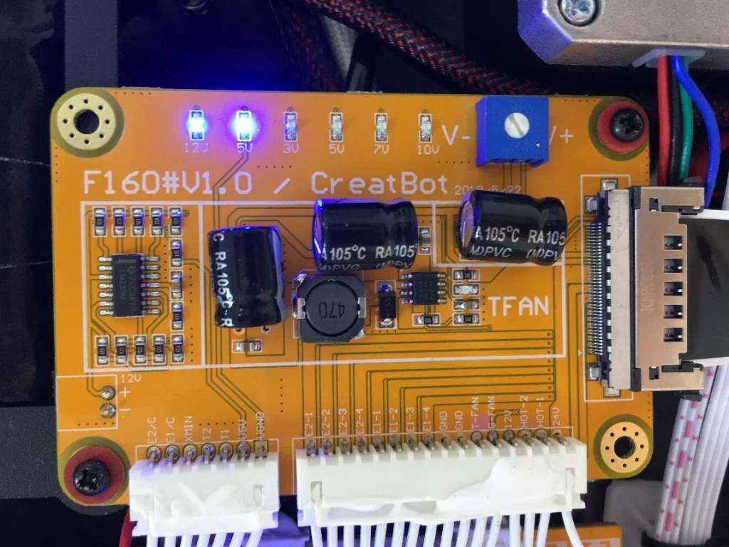 CreatBot F160 circuit board displaying capacitors, LEDs, and connectors, showcasing internal electronics of 3D printer with visible branding.