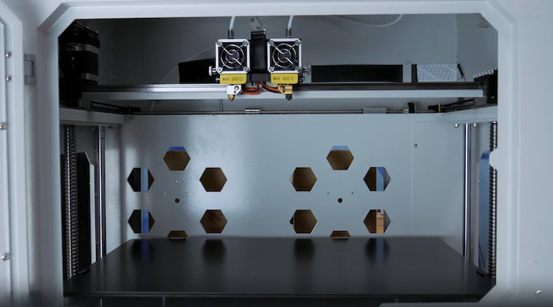 Creatbot F430 3D printer interior shows dual extruders and hexagonal ventilation, ideal for producing high-quality parts with precise engineering.