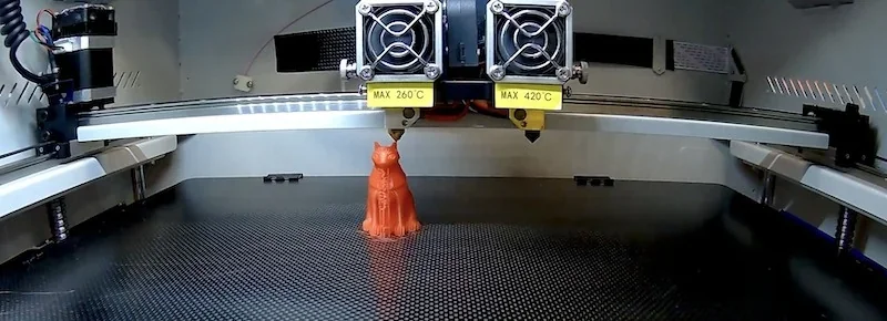 Creatbot F430 3D printer creating an orange cat model. Dual extruders labeled max 260°C and 420°C. Printer bed with carbon texture.