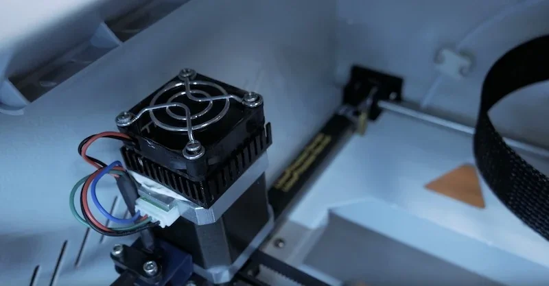 3D printer interior showing components of Creatbot F430, with wiring and cooling fan detail, demonstrating precise engineering and advanced technology.