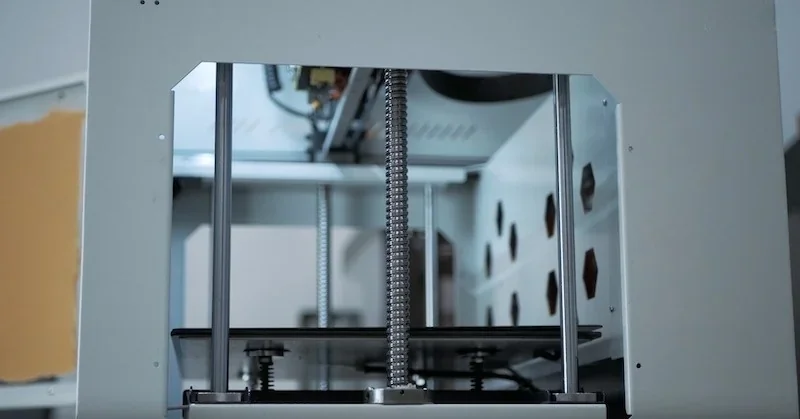 Creatbot F430 3D printer with visible metal rods and interior, showcasing its precision mechanics and technical design.