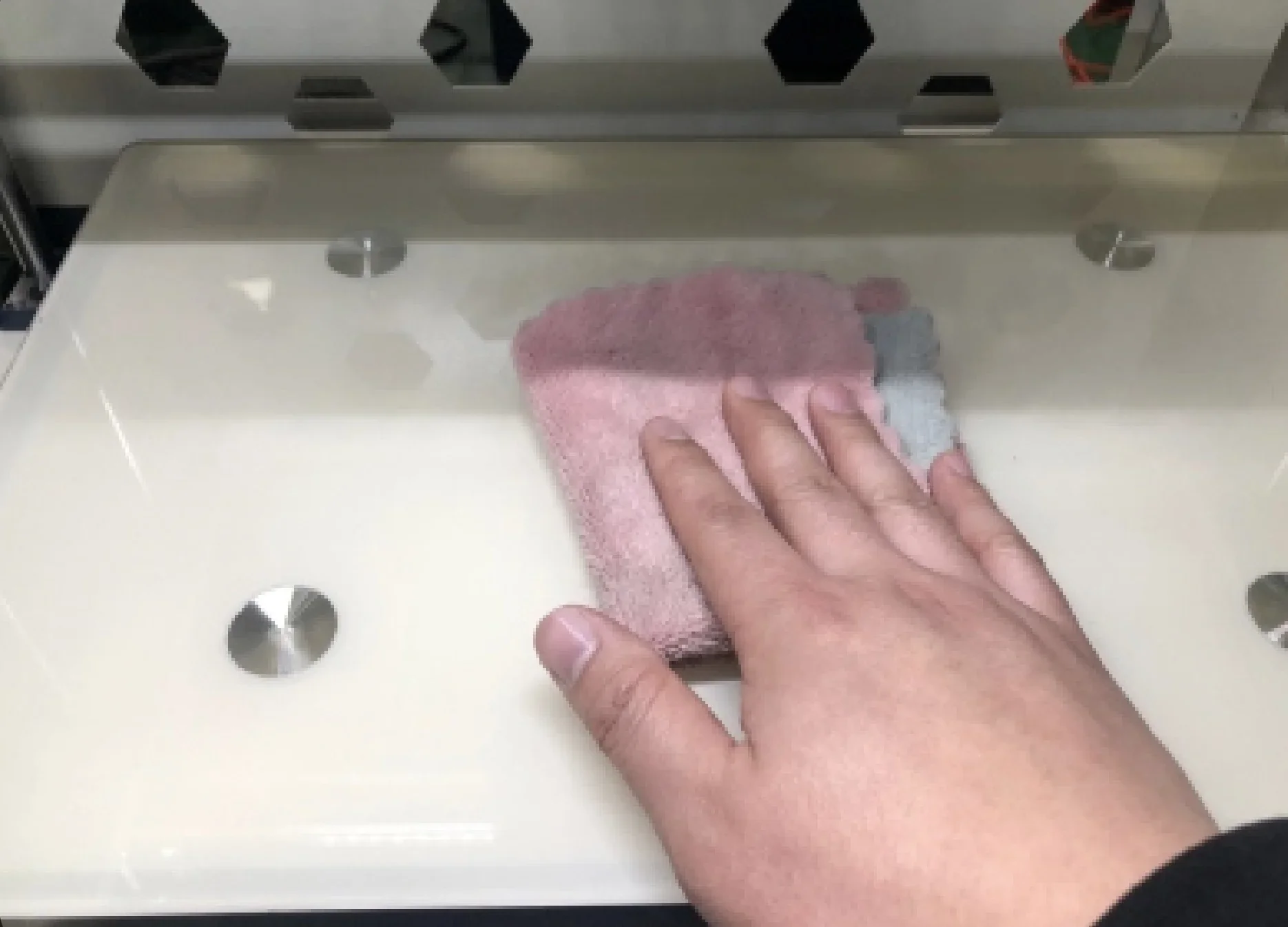 Hand cleaning the Creatbot F430's print bed with a pink cloth, showcasing maintenance and care for optimal 3D printing performance.