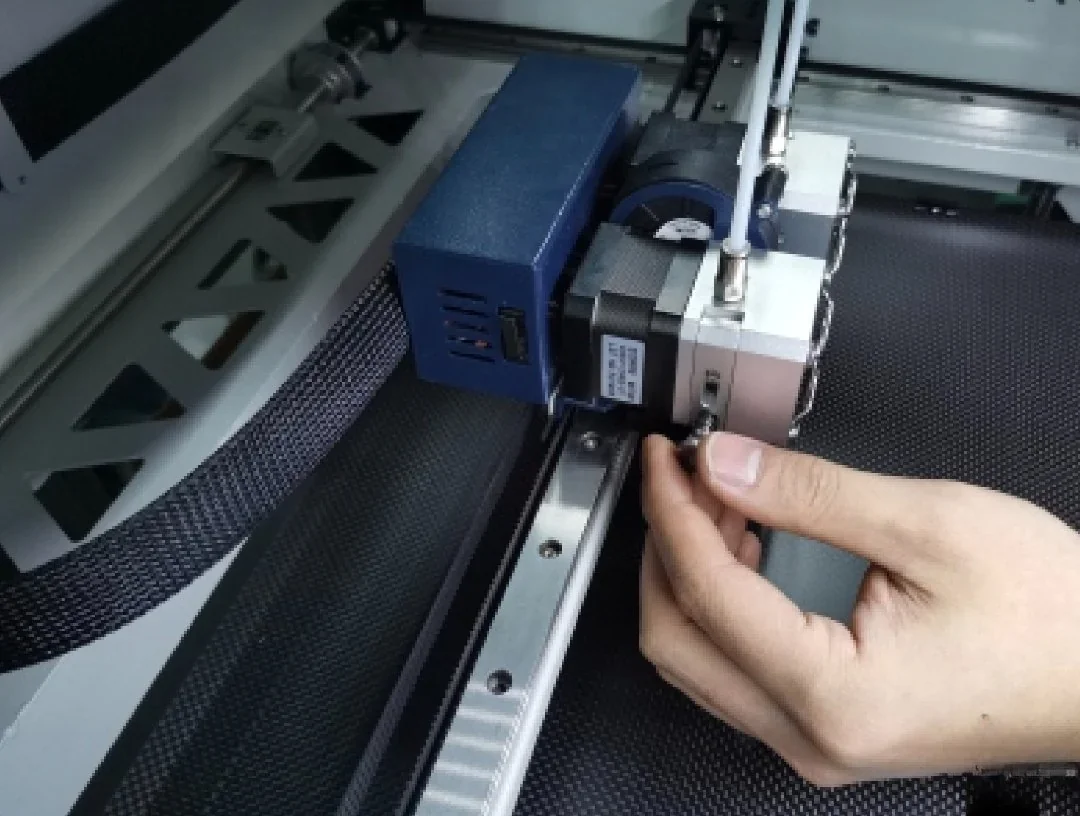 Creatbot F430 printer nozzle adjustment with hand, showing intricate components and wiring inside the printing chamber.