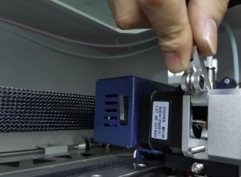 Creatbot F430 nozzle close-up, focused on adjustment process, shows precision engineering and build quality in a commercial 3D printer setting.