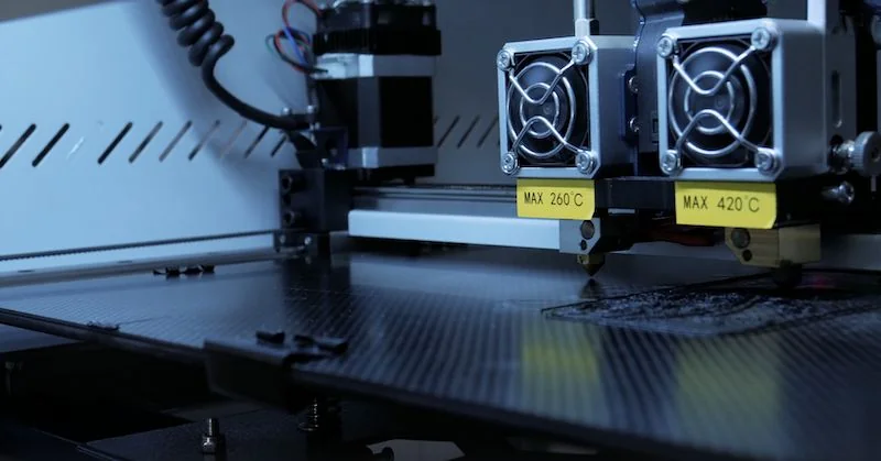 Creatbot F430 3D printer with dual extruders and labeled temperature limits, producing precise parts on a carbon-fiber textured build plate.