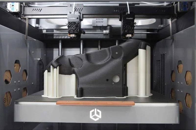 Creatbot F430 NX printing a large black part with white supports inside the 3D printer enclosure, showcasing dual extruder setup and branding.