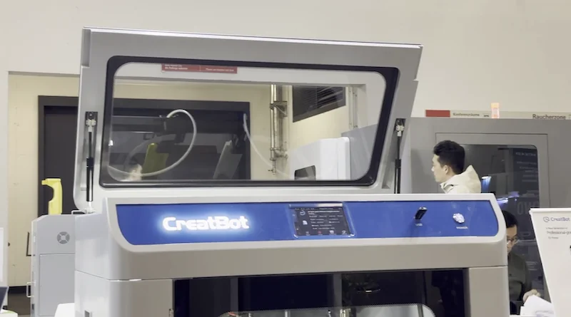 CreatBot F430 NX 3D printer in a tech setting, prominently displayed with open lid, showcasing innovation in industrial printing technology.