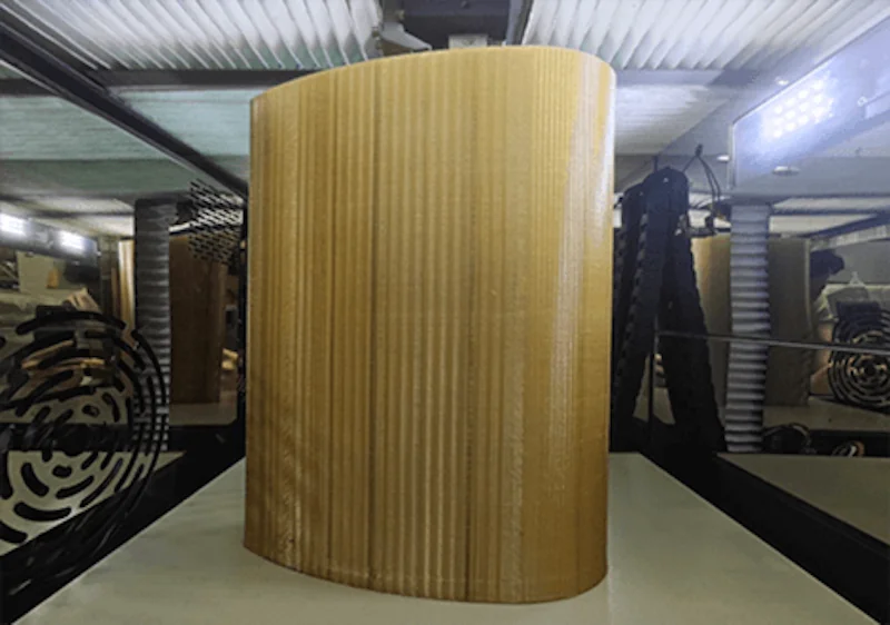 Creatbot PEEK-250 3D printer displaying a large, ribbed, cylindrical part, demonstrating precision engineering in a well-lit industrial setting.