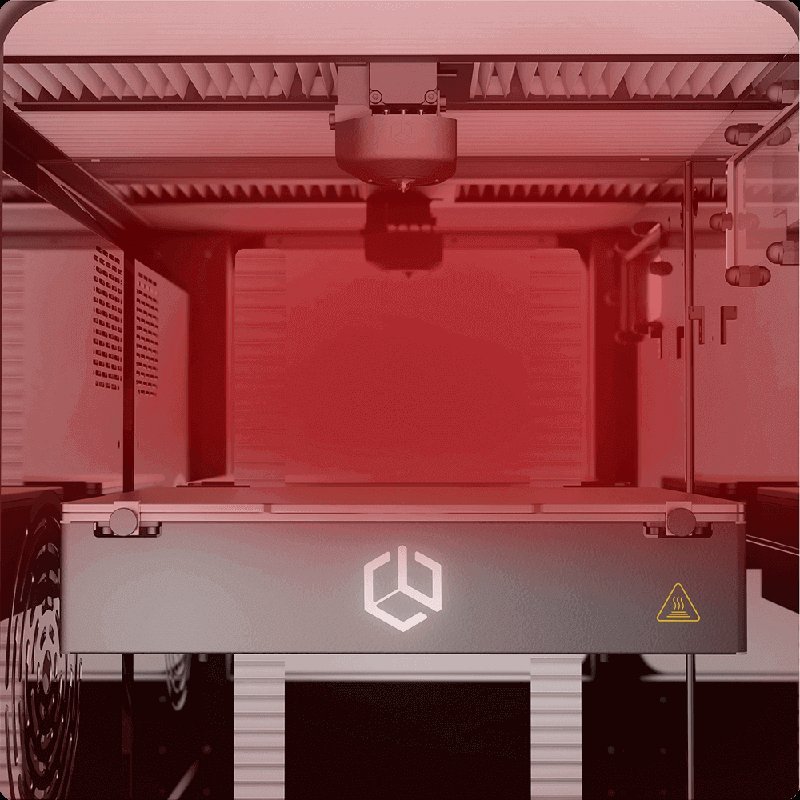 This image highlights the interior of the CreatBot PEEK-250 printer with a focus on its active printing area, enveloped in a red lighting effect. The printer head is centrally positioned, with visible guide rails and a heat warning symbol on the lower section. The image emphasizes the printer’s enclosed chamber, beneficial for maintaining uniform temperature during the printing process.