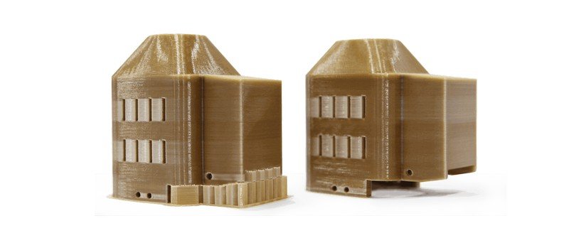 Two brown 3D printed models showcasing intricate geometric designs, likely created using the Creatbot PEEK-250. The models have a complex structure with multiple rectangular indents and smooth surface finishes, illustrating the printer's precision and capability in handling high-performance materials.