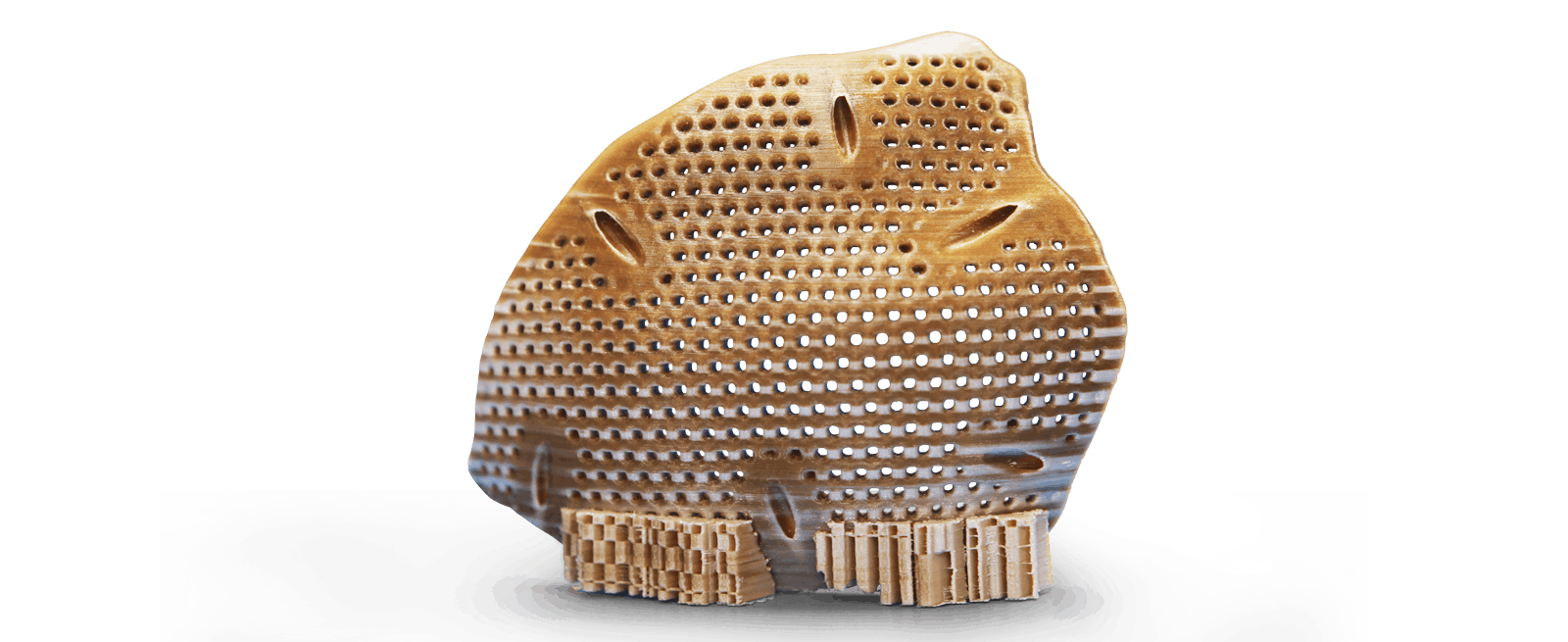 3D printed textured part created by creatbot peek-300, featuring a perforated design and brown gradient, on a light surface.