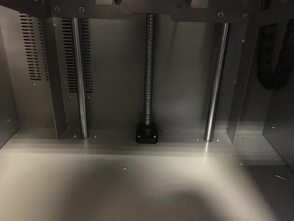 CreatBot PEEK-300 3D printer's interior showing metal rods and screws, highlighting its durability and structural components for high-temperature printing.