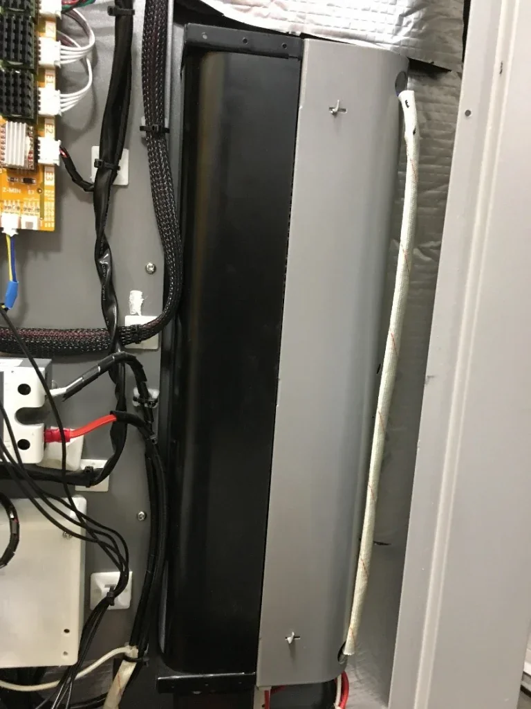 CreatBot PEEK-300 printer internals showing wiring and components; sleek design indicates advanced functionality in a workshop setting.