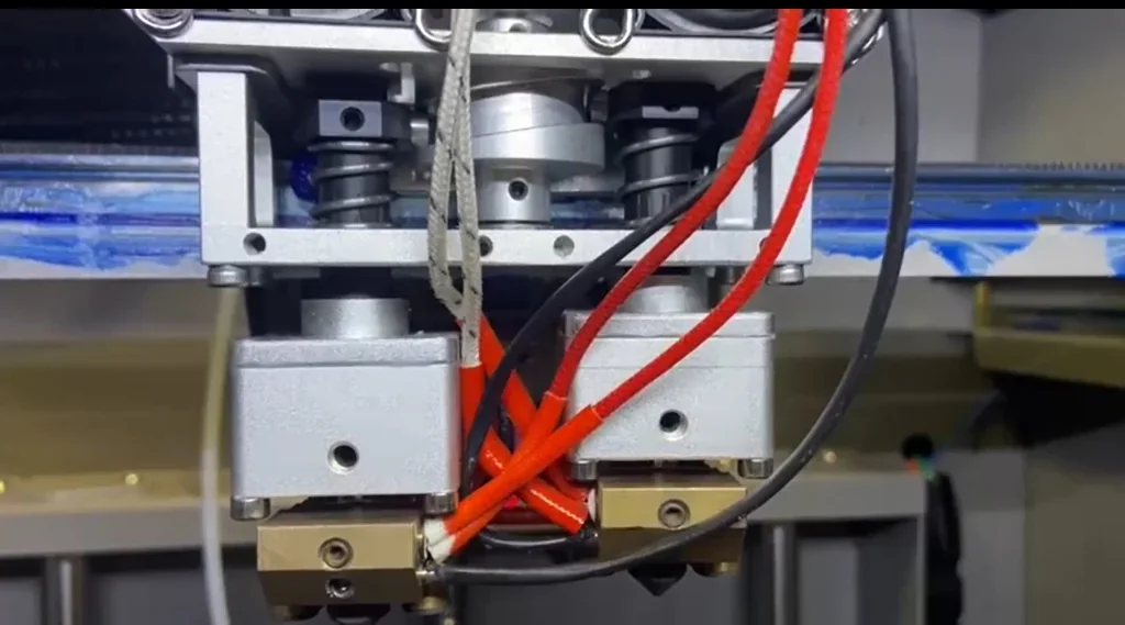Creatbot PEEK-300 3D printer close-up showing intricate wiring and mechanical components, likely used for producing precise high-temperature parts.