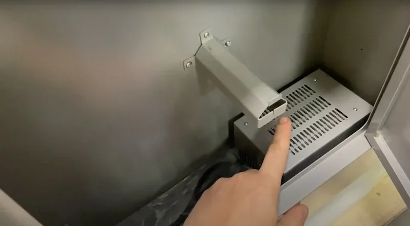 Hand points to a component inside the Creatbot PEEK-300 3D printer, highlighting its internal design and structure.