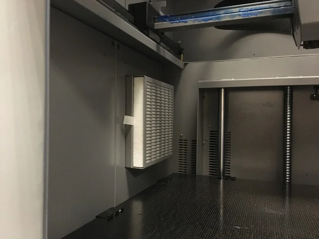 Creatbot PEEK-300 interior with grid filter and metallic components, showcasing advanced 3D printing technology.