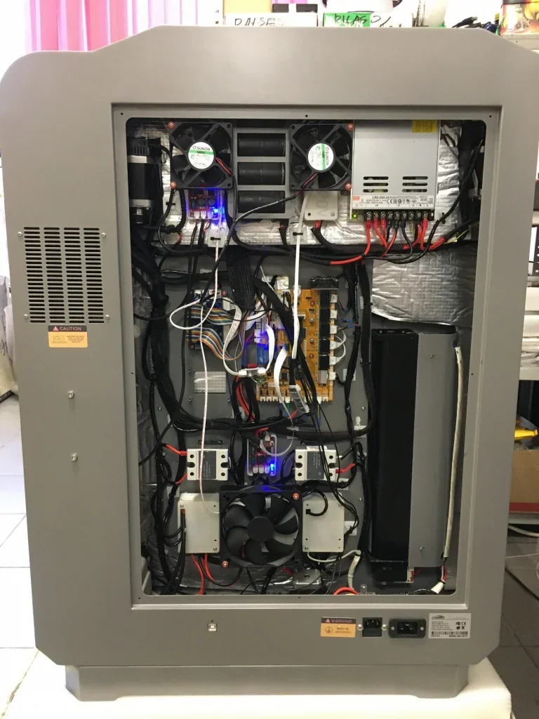 Creatbot PEEK-300 3D printer internals with wiring, circuit boards, and cooling fans showcased in a lab setting.