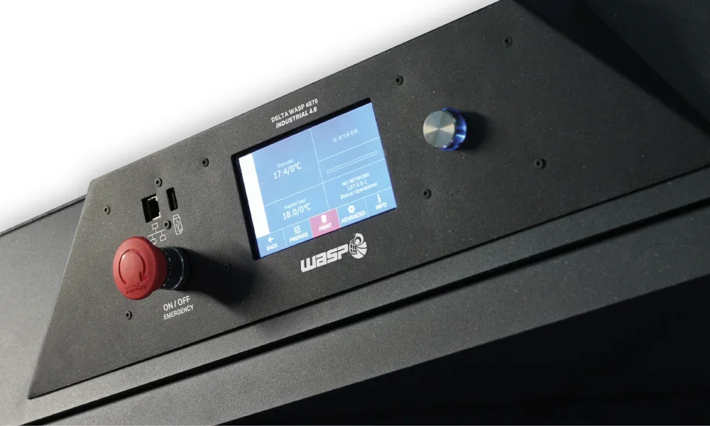 Delta Wasp 2040 Industrial X control panel with touchscreen, red emergency stop button, branding visible on a black 3D printer.