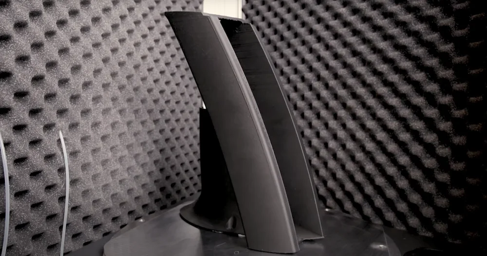 Delta Wasp 2040 Industrial X prints a large, black architectural model, surrounded by soundproofing foam panels.