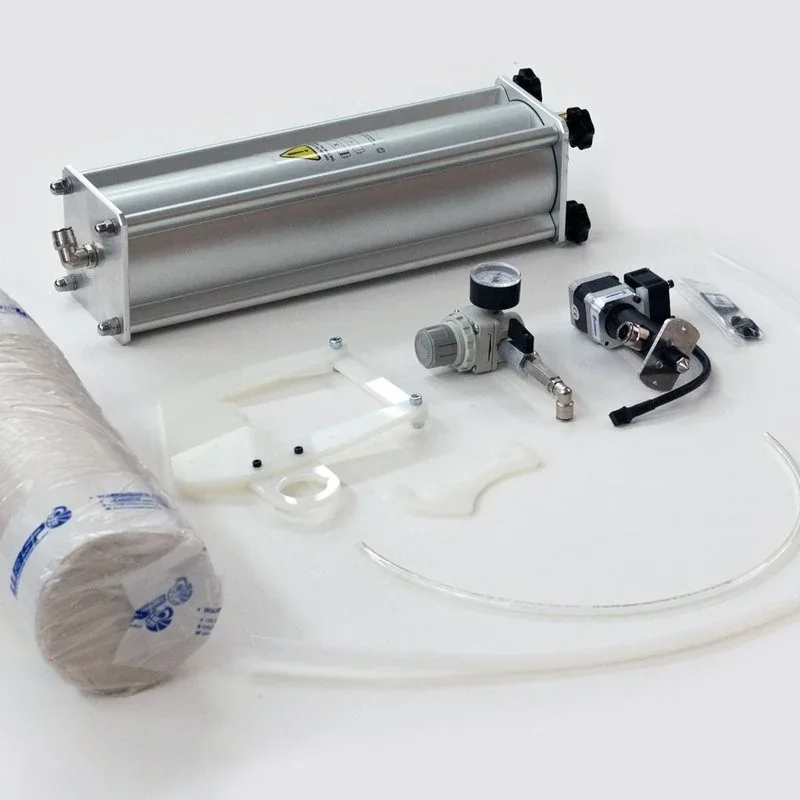 Delta Wasp 40100 Clay components, including a pneumatic cylinder, regulator, tubing, and clay rolls, displayed on a white surface.