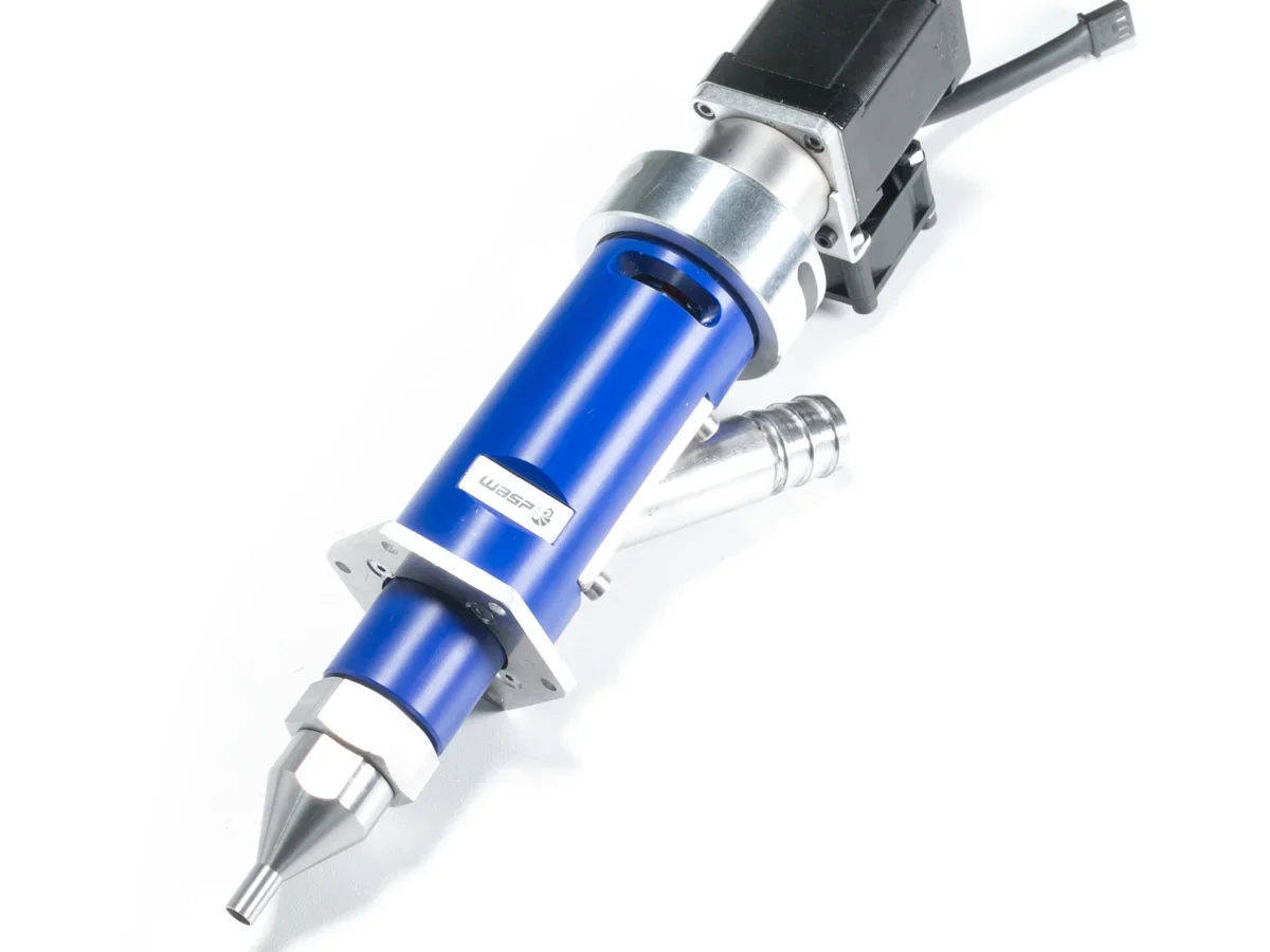 Delta WASP 40100 Clay extruder nozzle, blue and metallic, with branding. Used for creating 3D printed clay samples, shown in a technical setting.