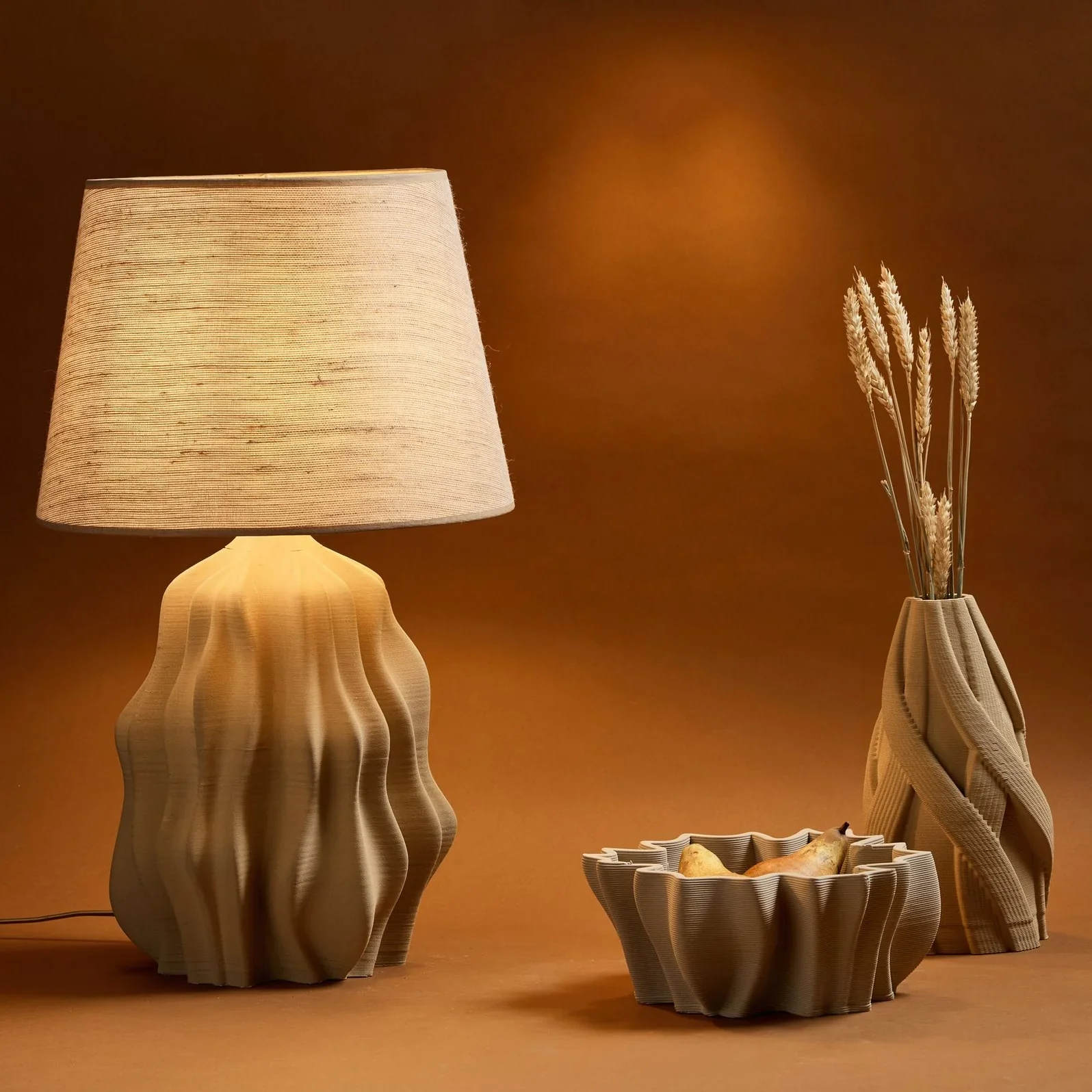 Delta Wasp 40100 Clay created wavy ceramic lamp base, vase, and bowl on brown background, showcasing 3D printed texture and design.