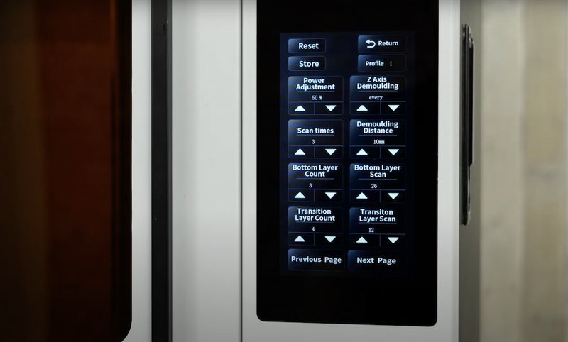 The display screen of the Emake3D Galaxy 1 3D printer presents various operational settings and controls. It features a sleek interface framed by a minimalistic, modern enclosure, indicative of a well-designed industrial product. The touchscreen shows multiple options, including 