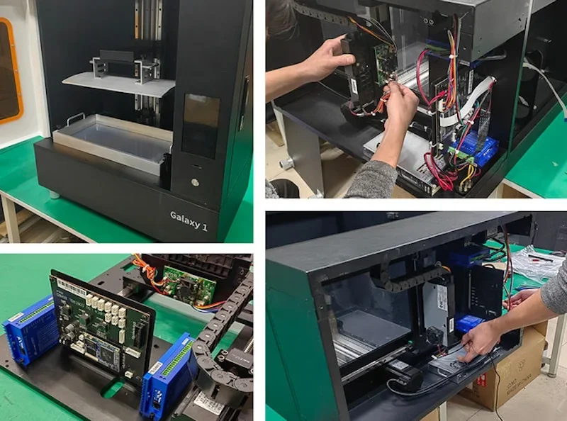 emake3d Galaxy 1 3D printer with open panels showing internal wiring and components on a workbench, highlighting detailed assembly and design features.